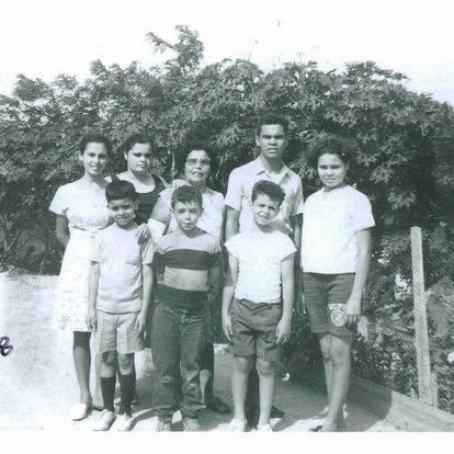 “My family! Self timer, early days! Dad set it up and ran while we ate mangoes! Even puppy (Mr. Tom Jones) was smiling!”
